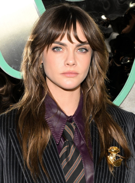 Cara Delevingne wearing a suit and tie